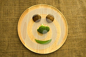 Fresh shitake mushroom,broccoli and green pea on wooden dishware