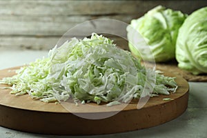 Fresh shredded cabbage on light table, closeup