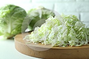 Fresh shredded cabbage on light table, closeup