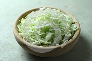 Fresh shredded cabbage on light table, closeup