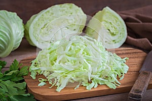Fresh shredded cabbage on wooden cutting board