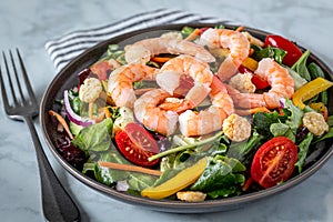 Fresh shrimp and greens salad on light background