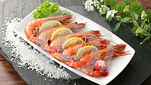 Fresh shrimp prawn seafood plate with shellfish shrimps and lemon herb, Seafood fresh shrimps boil or steam for cook food with