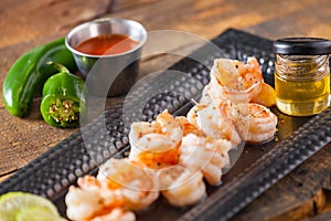 Fresh Shrimp Served On Black Plate On Wooden Table Cooked With H