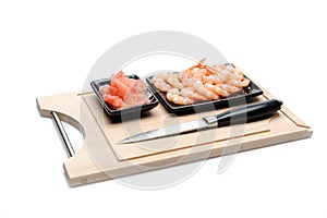 Fresh shrimps and ingver on wooden board