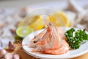 Fresh shrimps prawns seafood lemon lime with herbs and spice, Shrimp on white plate for cooking food