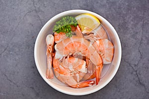 Fresh shrimps served on white bowl, boiled peeled shrimp prawns cooking in the seafood restaurant