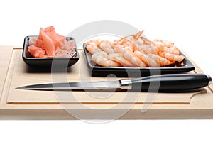 Fresh shrimps on wooden board isolated