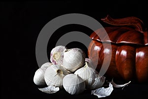 Fresh Single Clove Garlics or pearl garlic or solo garliwith a wood spice box c