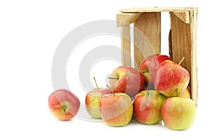 Fresh `Sissi red` apples in a wooden crate