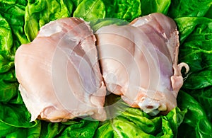 Fresh skinless chicken thighs on salad