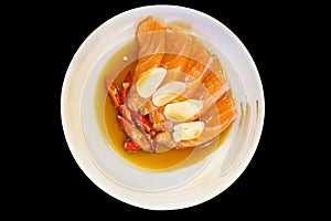 Fresh slice salmon in fish sauce on white round plate