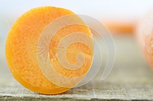 cuts sliced of carrot on wooden, rustic