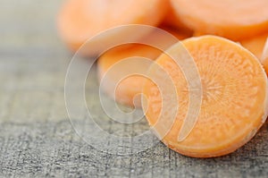 Fresh sliced carrots on wooden, closeup