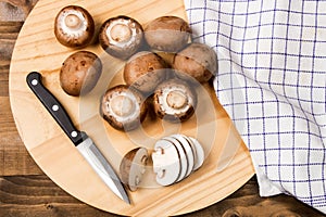 Fresh and sliced chestnut mushroom on a wooden board