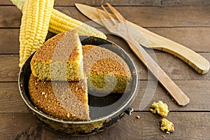 Fresh,Sliced of Cornbread on the wooden table with corns and wooden knife.