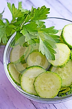 Fresh sliced cucumbers in a glass plate.