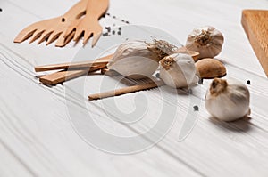 Fresh sliced garlic in glass bowl on wooden background