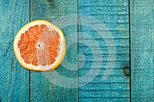 Fresh sliced grapefruit on a blue wooden background