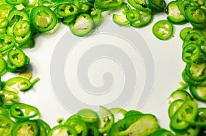 Fresh sliced green jalapeno peppers on a white background, spicy flavor ingredient in many dishes