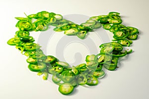 Fresh sliced green jalapeno peppers on a white background, spicy flavor ingredient in many dishes