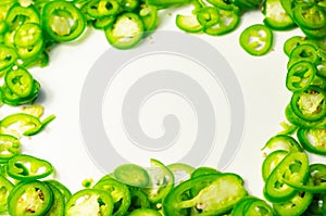 Fresh sliced green jalapeno peppers on a white background, spicy flavor ingredient in many dishes