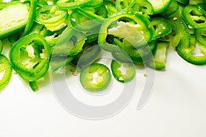 Fresh sliced green jalapeno peppers on a white background, spicy flavor ingredient in many dishes
