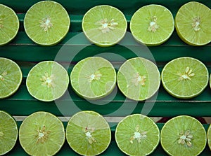 Fresh sliced green lemons or lime. Ripe juicy lemonade background.