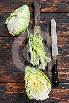 Fresh sliced Green pointed cabbage. Wooden background. Top view