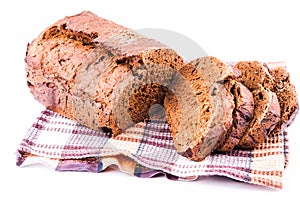 Fresh sliced homemade brown bread with cereals on a kitchen towel