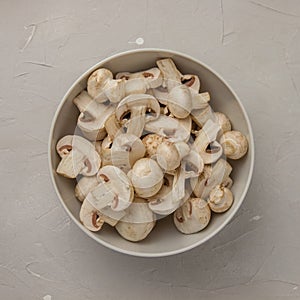 Fresh sliced mushrooms in a round porcelain bowl