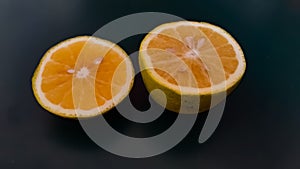 Fresh sliced orange fruits with dark background