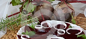 Fresh sliced organic beetroot with onion decorated on a white plate