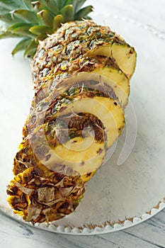 Fresh sliced pineapple on a cutting board