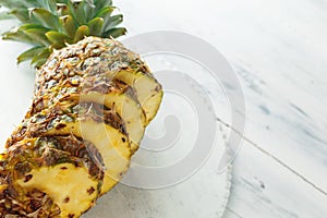 Fresh sliced pineapple on a cutting board