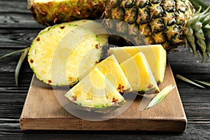 Fresh sliced pineapple on wooden board,