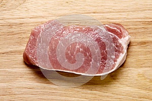 Fresh sliced pork filled on a wooden board