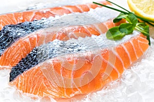 Fresh sliced salmon portions on ice. photo