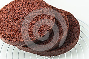 Fresh sliced sponge chocolate cake biscuit. Cake assembly process background. Cake recipe