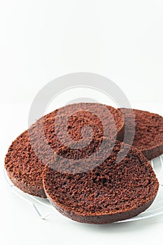 Fresh sliced sponge chocolate cake biscuit. Cake assembly process background. Cake recipe