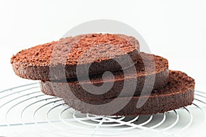 Fresh sliced sponge chocolate cake biscuit. Cake assembly process background. Cake recipe