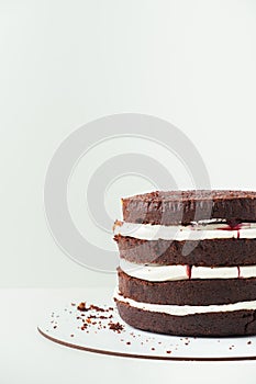 Fresh sliced sponge chocolate cake biscuit layers filled with whipped cream cheese. Cherry cake assembly process. Cake recipe