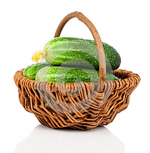 Fresh small cucumbers in a wicker basket