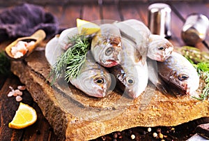 Fresh small fish on stone board