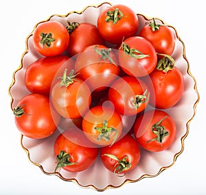 Fresh small tomatoes in white salad bowl