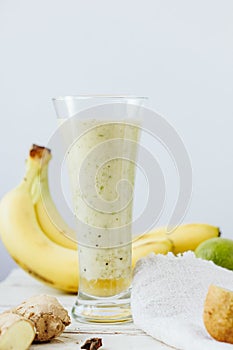 Fresh smothie - vegan drink with banana, salad leaves, ginger and kiwi.