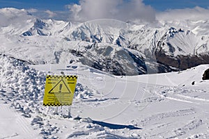 Fresh snow and danger sign at the off piste terrain at the Meribel ski area.