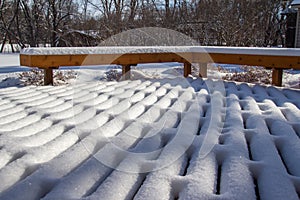 Fresh snow designs on a wooden deck