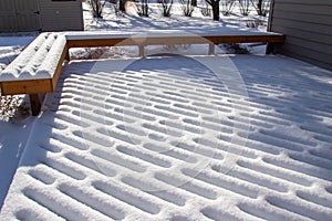 Fresh snow designs on a wooden deck