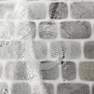 Fresh snow on the ectangle pavement